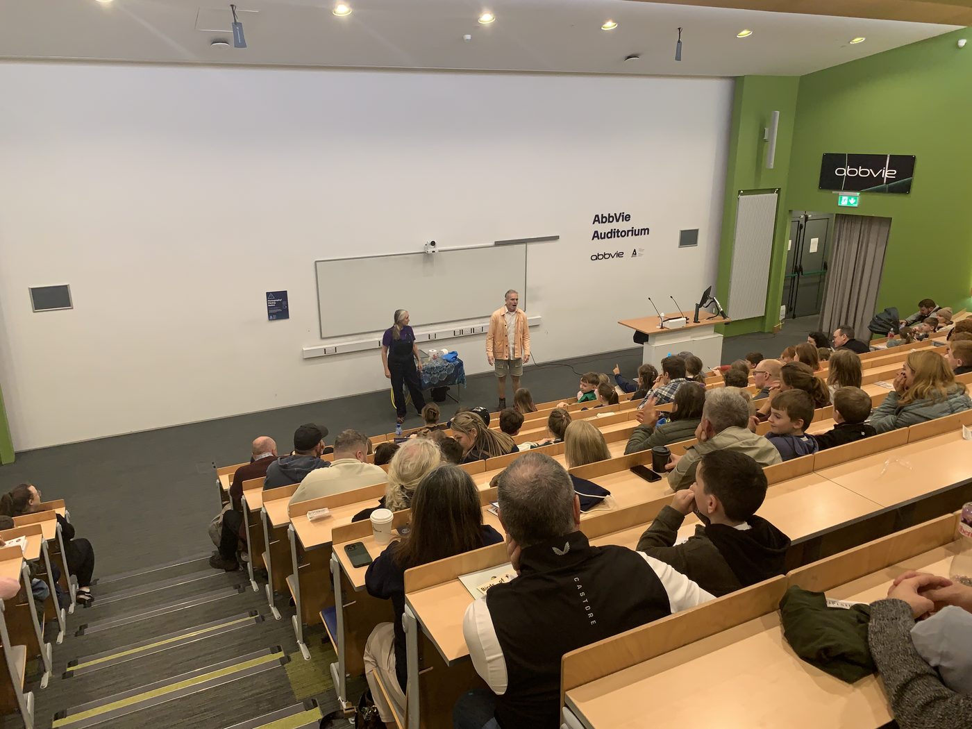 Karsten leading a session in a large lecture theatre, with an audience in the seats